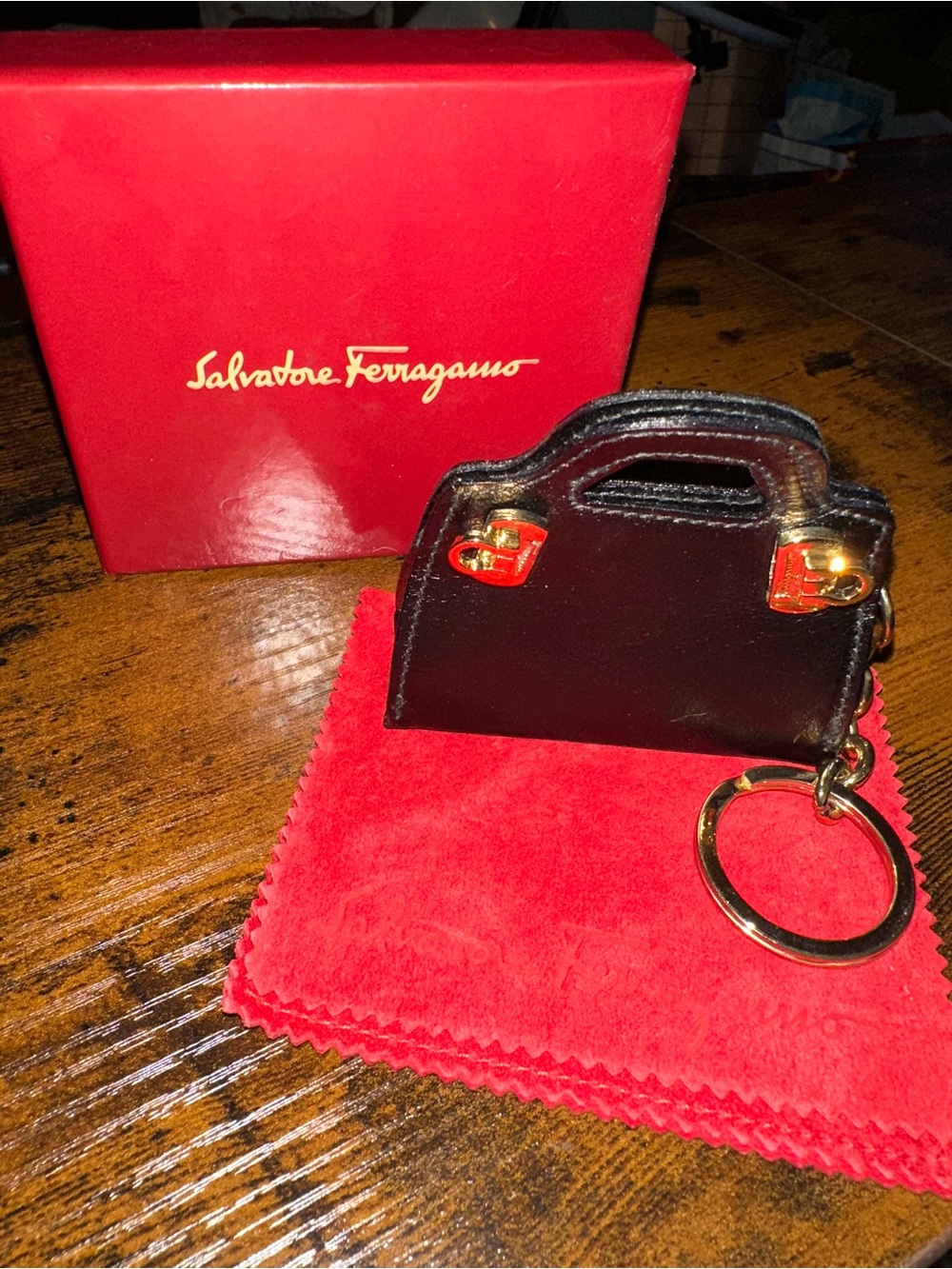 Salvatore Ferragamo mini leather handbag charm featuring distinct gold hardware